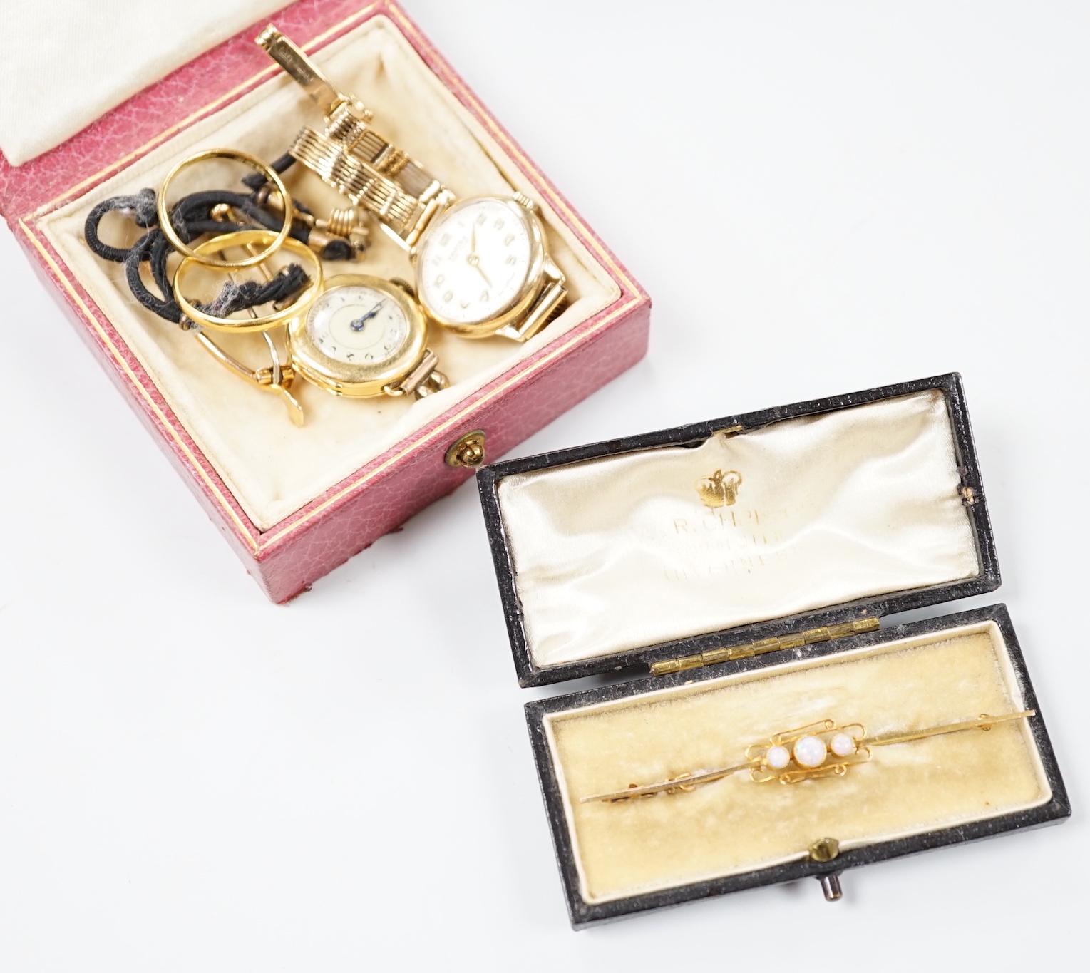 A small collection of gold jewellery and other items to include two 22ct. yellow gold wedding bands, 4.5 grams, a yellow metal wishbone bar brooch, a 9ct. yellow gold cased Vertex lady's wristwatch on a 9ct gold strap, g